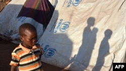 FILE - Refugees wait for registration at the Kapisi refugee camp in Malawi's Mwanza district on the Malawi-Mozambique border, Jan. 7, 2015.