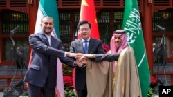 FILE - Iran's Foreign Minister Hossein Amirabdollahian, left, meets with his Saudi Arabian counterpart Prince Faisal bin Farhan Al Saud, right, and China's Qin Gang in Beijing, April 6, 2023.