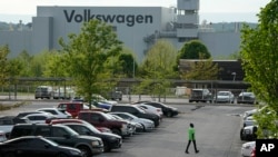 A person walks across the parking lot at the Volkswagen automobile plant in Chattanooga, Tennessee, April 19, 2024. Workers at the plant voted late that day to join the United Auto Workers union.