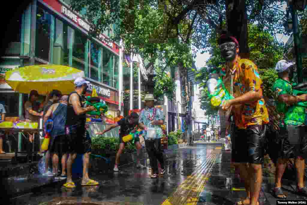 Foreign tourists enjoy the Songkran celebrations by participating in the public water fights, Asoke, Bangkok, April 13, 2024.