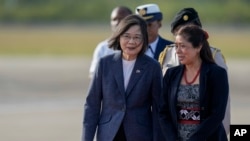 Taiwan's President Tsai Ing-wen, left, listens to Froylan Tzalam, governor general of Belize, as she arrives at Philip S.W. Goldson International Airport in Belize City, April 2, 2023.