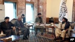 FILE - Mullah Abdul Ghani Baradar, the Taliban-appointed deputy prime minister for economic affairs, right, speaks with Pakistan's defense minister, Khawaja Mohammad Asif, during a meeting in Kabul, Feb. 22, 2023.