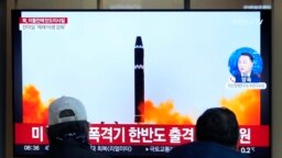 A TV screen shows a file image of North Korea's missile launch during a news program at the Seoul Railway Station in Seoul, South Korea, Feb. 20, 2023. 