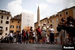 FILE - People queue to enter Pantheon, one of the ancient world's best preserved monuments which from July will start charging visitors an entry fee in Rome, Italy, June 30, 2023.