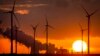 FILE - Steam rises from the coal-fired power plant near wind turbines Niederaussem, Germany, as the sun rises on Wednesday, Nov. 2, 2022. 