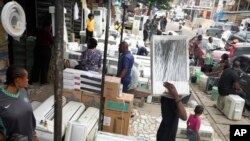 People sell air conditioners on the street in Lagos, Nigeria, July 15, 2024.