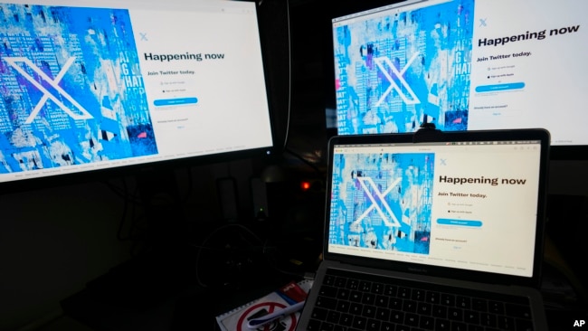 FILE - Screens display the sign-in page of the social media platform X — formerly known as Twitter — July 24, 2023, in Belgrade, Serbia. Rights advocates are urging social media platforms to do more to prevent Chinese authorities from obtaining the personal information of users.