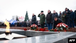 FILE - Mourners gather to lay flowers in memory of more than 60 Russian soldiers that Russia says were killed in a Ukrainian strike on Russian-controlled territory, in Samara, on Jan. 3, 2023. 