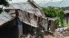A man stands outside his damaged home in Blantyre, Malawi, Monday, March 13, 2023. An unrelenting Cyclone Freddy that is currently battering southern Africa has killed at least 56 people in Malawi and Mozambique since it struck the continent for a second time on Saturday night.AP