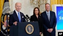 FILE - President Joe Biden, with Vice President Kamala Harris and her husband, Douglas Emhoff, speaks during a reception marking the Jewish new year at the White House in Washington, Sept. 30, 2022. Biden on May 25, 2023, announced a U.S. government effort to fight antisemitism.