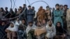 FILE - Afghan refugees wait to register in a camp near the Torkham Pakistan-Afghanistan border in Torkham, Afghanistan, Nov. 4, 2023. 