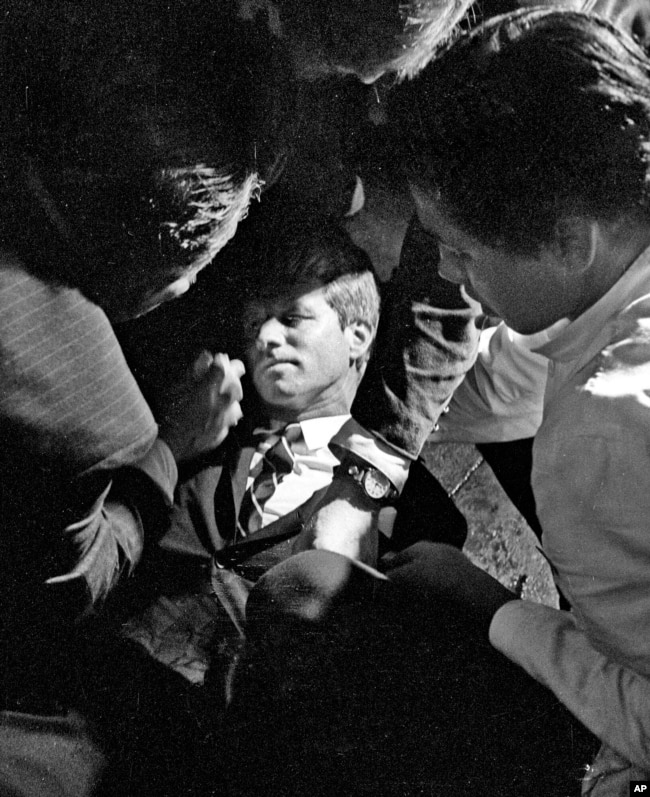 FILE - In this June 5, 1968 file photo, Senator Robert F. Kennedy, lies on the floor of the Ambassador Hotel in Los Angeles moments after he was shot. (Richard Drew/Pasadena Star News via AP, File)