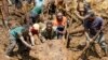 Villagers move a rock as part of search efforts following a devastating landslide, in Yambali village, in the Highlands of Papua New Guinea, May 27, 2024. (Juho Valta/UNDP Papua New Guinea via AP)