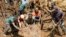 Villagers move a rock as part of search efforts following a devastating landslide, in Yambali village, in the Highlands of Papua New Guinea, May 27, 2024. (Juho Valta/UNDP Papua New Guinea via AP)