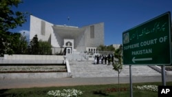 FILE - Lawyers are seen gathered outside Pakistan's Supreme Court in Islamabad, April 4, 2023. The court's proceedings were broadcast live on TV for the first time Monday.