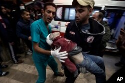 A Palestinian child wounded during the Israeli bombardment of the Gaza Strip is brought to the Nasser hospital in Khan Younis, Southern Gaza Strip, Jan. 6, 2024.
