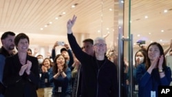 Apple CEO Tim Cook attends the opening of a new flagship Apple store in Shanghai, China, March 21, 2024, in this photo provided by China's Xinhua News Agency.