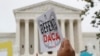 FILE - People rally outside the U.S. Supreme Court in Washington to defend the Deferred Action for Childhood Arrivals program known as DACA, Nov. 12, 2019. 