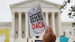 FILE - People rally outside the U.S. Supreme Court in Washington over President Donald Trump's decision to end the Deferred Action for Childhood Arrivals program, Nov. 12, 2019. 