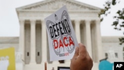 FILE - People rally outside the U.S. Supreme Court in Washington over President Donald Trump's decision to end the Deferred Action for Childhood Arrivals program, Nov. 12, 2019. 