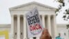 FILE - People rally outside the US Supreme Court over President Donald Trump's decision to end the Deferred Action for Childhood Arrivals program (DACA), at the Supreme Court in Washington, Nov. 12, 2019. 