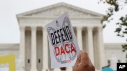 FILE - People rally outside the US Supreme Court over President Donald Trump's decision to end the Deferred Action for Childhood Arrivals program (DACA), at the Supreme Court in Washington, Nov. 12, 2019. 