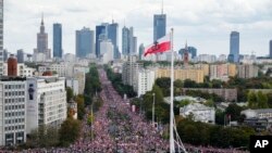 Thousands march in support of the opposition against the governing populist Law and Justice party in Warsaw, Poland, Oct. 1, 2023. Opposition leader Donald Tusk seeks to boost his election chances for the parliament elections on Oct. 15, 2023.