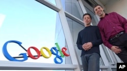 FILE - Google co-founders Sergey Brin, left, and Larry Page pose for a photo at the company's headquarters in Mountain View, California, on January 15, 2004.