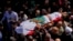 Mourners carry the body of Reuters videographer Issam Abdallah during his funeral procession in his hometown of Khiam, southern Lebanon, Oct. 14, 2023. 