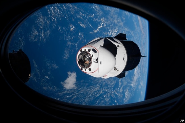 FILE - In this April 24, 2021 file photo made available by NASA, the SpaceX Crew Dragon capsule approaches the International Space Station for docking.