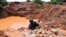FILE - Gold miners work in Kakamega, 395 kilometers from the capital in the western province of Kenya, on August 7, 2014. 