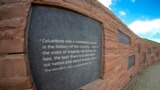 In this view through a fisheye lens, a plaque with a quote from President Bill Clinton is displayed on the wall of healing at the Columbine Memorial, April 17, 2024, in Littleton, Colorado. 