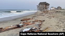 This photo provided by the National Park Service, Aug. 16, 2024, in Rodanthe, North Carolina, along the Cape Hatteras National Seashore shows debris from an unoccupied beach house that collapsed into the Atlantic Ocean from winds and waves caused by Hurricane Ernesto. 