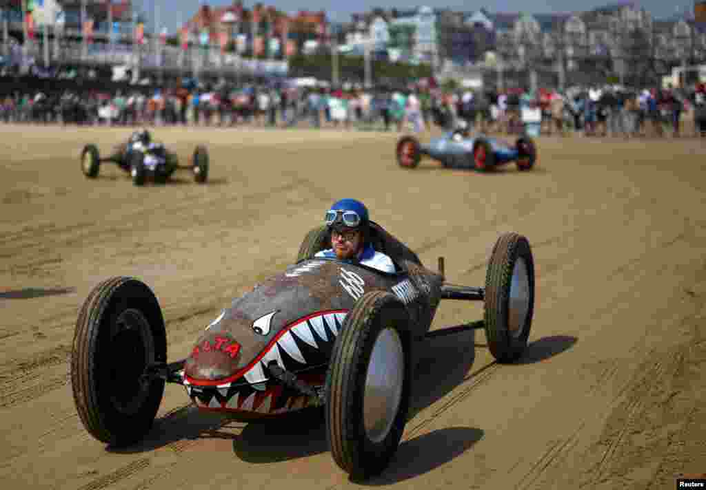 Motoring enthusiasts take part in the 'Race The Waves' classic car and motorcycle meet at the beach in Bridlington, Britain, May 12, 2024.