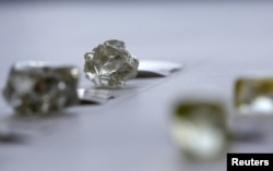 FILE - Diamonds are displayed at the De Beers Global Sightholder Sales (GSS) in Gaborone, Botswana, Nov. 24, 2015.