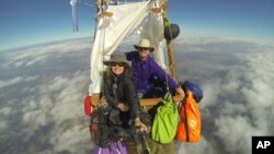 FILE - This Oct. 9, 2017, image provided by Cheri White shows Cheri White and pilot Mark Sullivan flying their gas balloon during a long-distance competition.