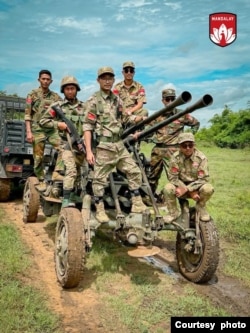 A group of soldiers from the People's Defense Force (Mandalay) are pictured with an anti-aircraft gun they seized from the junta's military base in Ingyin Myaing, near Mandalay, July 10, 2024. (Chief of Staff, People's Defense Force - Mandalay)