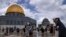 Palestinian volunteers clean the ground outside the Dome of Rock Mosque at the al-Aqsa Mosque compound ahead of the Muslims holy month of Ramadan, in Jerusalem's Old City, March 18, 2023.