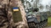 FILE - A Ukrainian soldier in front of a Marder infantry fighting vehicle in Munster, Germany, Feb. 20, 2023. Germany is giving Ukraine 2.7 billion euros more in military aid.
