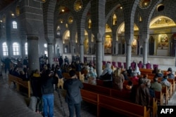 A priest celebrates the Easter mass at the Armenian church Surp Giragos, in Diyarbakir, southeastern Turkey, on April 9, 2023.