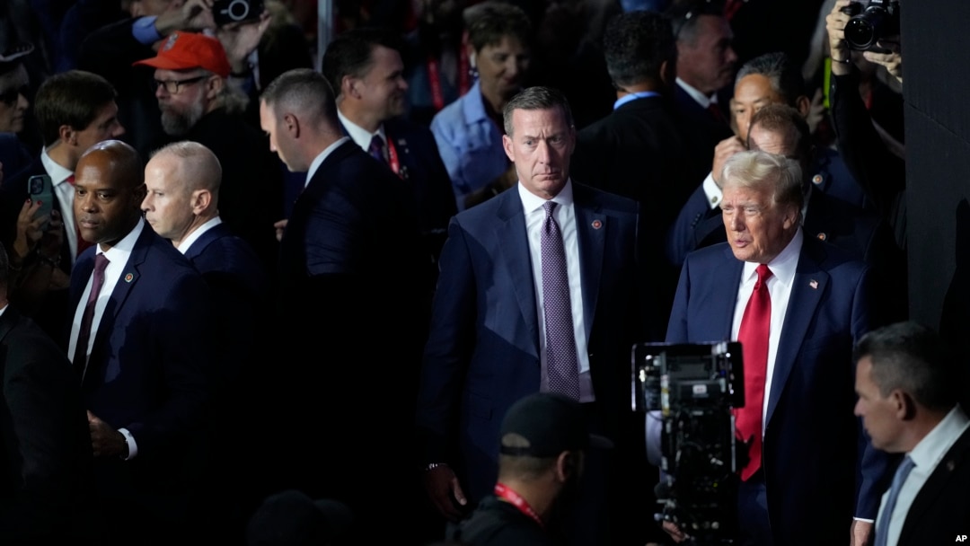 FILE - Republican presidential candidate former President Donald Trump, right, surrounded by members of the Secret Service, is seen arriving to attend the final night of the Republican National Convention in Milwaukee, Wisconsin, July 18, 2024.