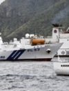 A China Coast Guard vessel sails near a Japan Coast Guard vessel Kabira off Uotsuri Island, one of a group of disputed islands called Senkaku Islands, also known in China as Diaoyu Islands, in the East China Sea, Apr. 27, 2024. (Kyodo/via Reuters) 