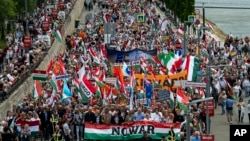 People march during a rally in support of Hungary's Prime Minister Viktor Orbán and his party in Budapest, Hungary, June 1, 2024.