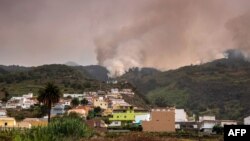 A wildfire rages out of control through forested slopes in La Matanza on the Canary island of Tenerife, Aug. 19, 2023.