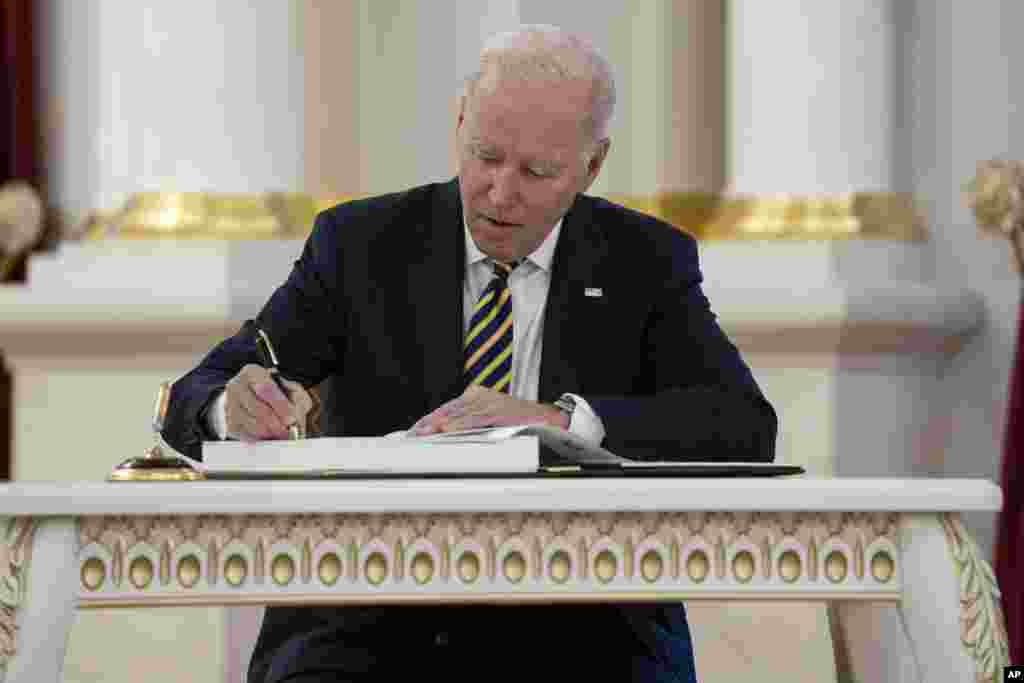 President Joe Biden signs the guest book at Mariinsky Palace, Feb. 20, 2023, in Kyiv.