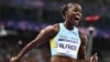 Saint Lucia's Julien Alfred celebrates winning the women's 100m final of the athletics event at the Paris 2024 Olympic Games at Stade de France in Saint-Denis, north of Paris, Aug. 3, 2024. 