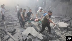 Palestinians evacuate wounded people after an Israeli airstrike in Rafah refugee camp, southern Gaza Strip, Oct. 12, 2023. 