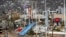 Residents walk past debris in the aftermath of Hurricane Otis in Acapulco, Mexico, Oct. 27, 2023.