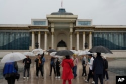 FILE - Korean tourists visit Sukhbaatar Square in Ulaanbaatar, Mongolia, June 27, 2024.