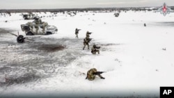FILE - In this handout photo taken from video released by Russian Defense Ministry Press Service on Dec. 28, 2022, Russian soldiers take part in drills at an unspecified location in Belarus.